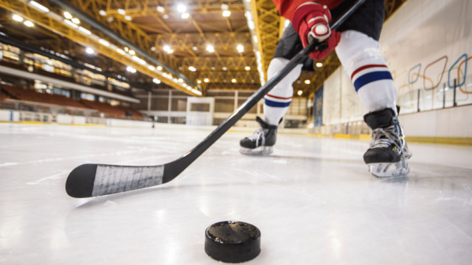 hockey-stick-and-puck-on-ice