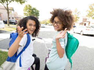 two-kids-on-bikes-with-backpacks