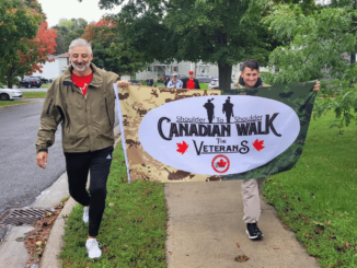 military-members-carry-the-walk-for-veterans-flag