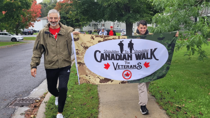 military-members-carry-the-walk-for-veterans-flag